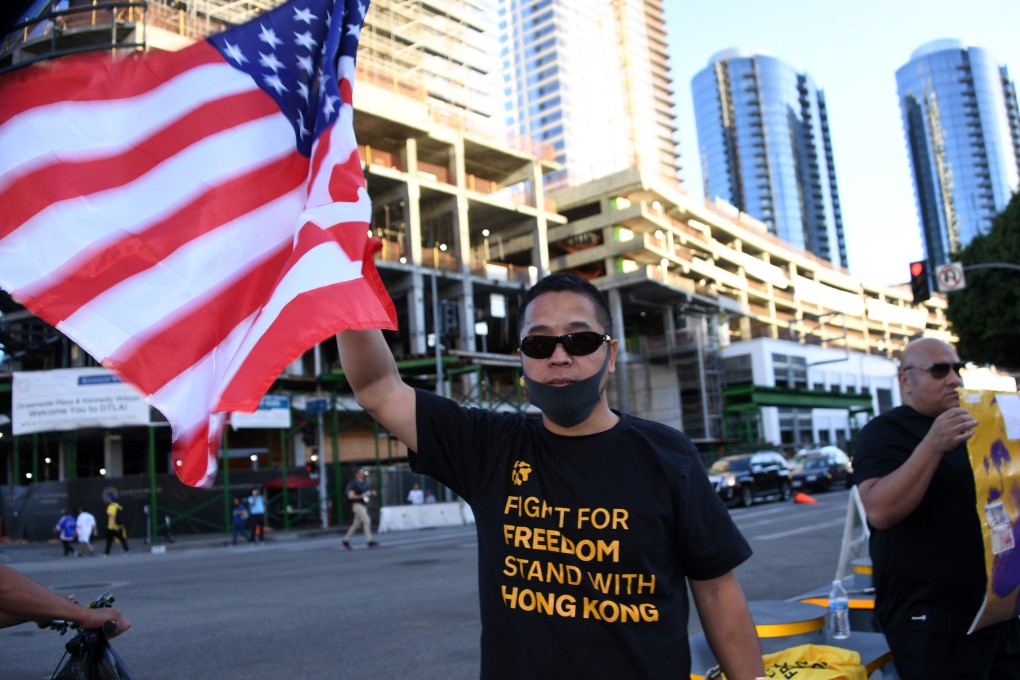 A fan wears a “Fight for Freedom, Stand with Hong Kong” T-shirt and holds a US flag before an NBA game at the Staples Center. Photo: USA Today Sports