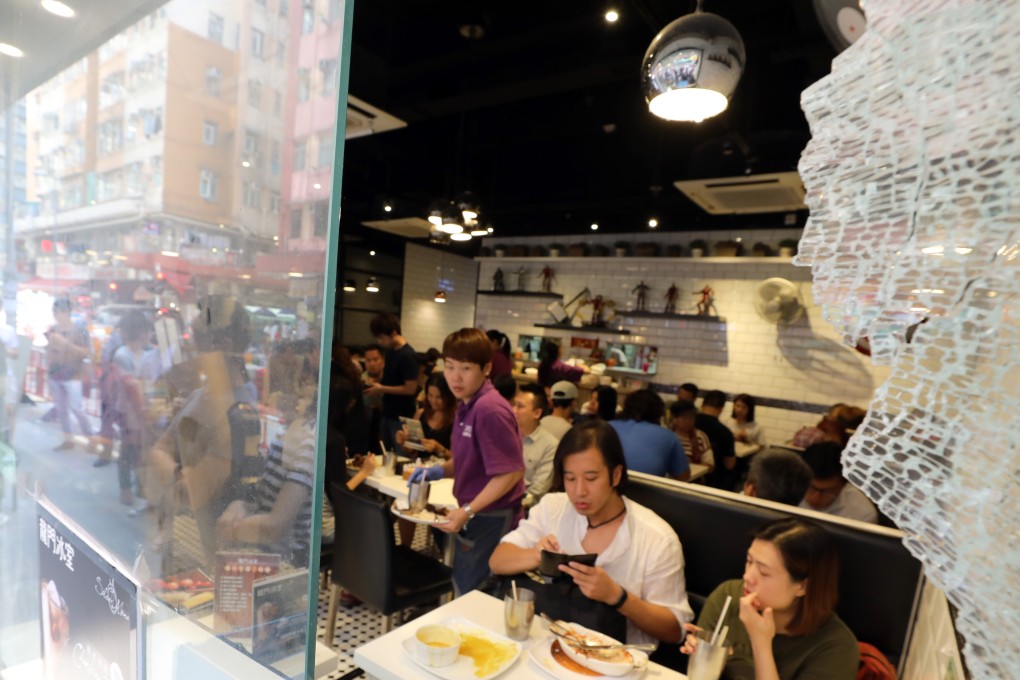 Lung Mun Cafe customers come out in force with the signs of the early morning attack still highly visible. Photo: Dickson Lee