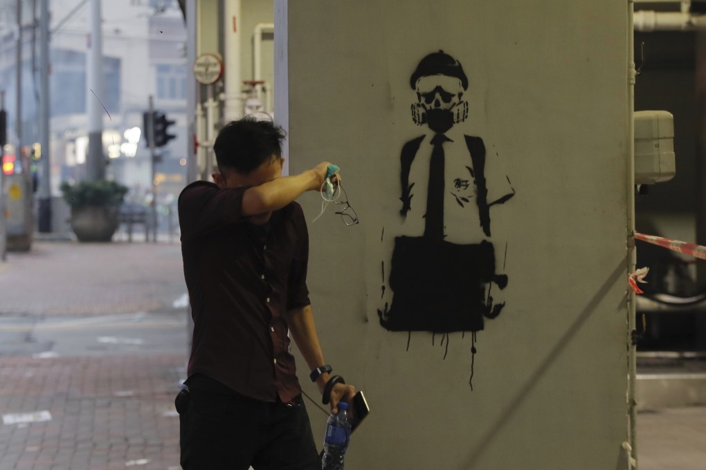 A man wipes his eyes after yet another weekend of tear gas on the streets of Hong Kong, on October 6. Photo: AP
