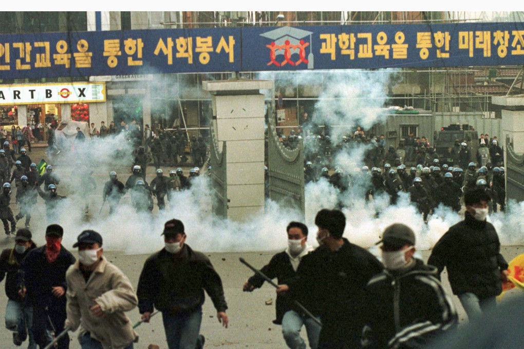 South Korean students disperse as tear gas is fired by riot police in this file photo. Photo: Reuters