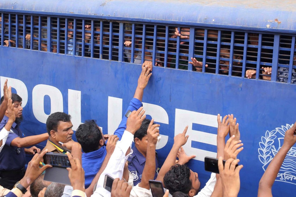 A prison van escorts the 16 accused away after they were given death sentences in a murder case in Feni, Bangladesh. Photo: Reuters