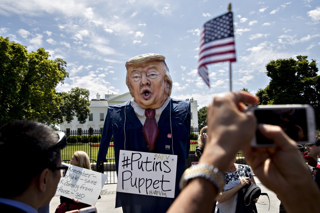 A demonstrator wears an effigy in the likeness of Donald Trump during a protest outside the White House in May 2017. Photo: Bloomberg