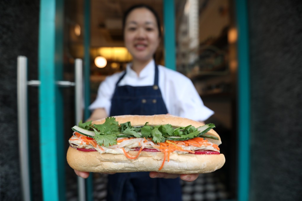 Le Petit Saigon chef Theign Yie Phan with a pork banh mi. Photo: Xiaomei Chen