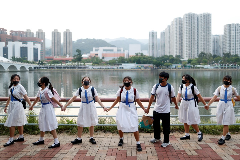 Masked students in school uniform form a human chain along Shing Mun River in Sha Tin as part of an anti-government protest on September 19. Photo: Reuters