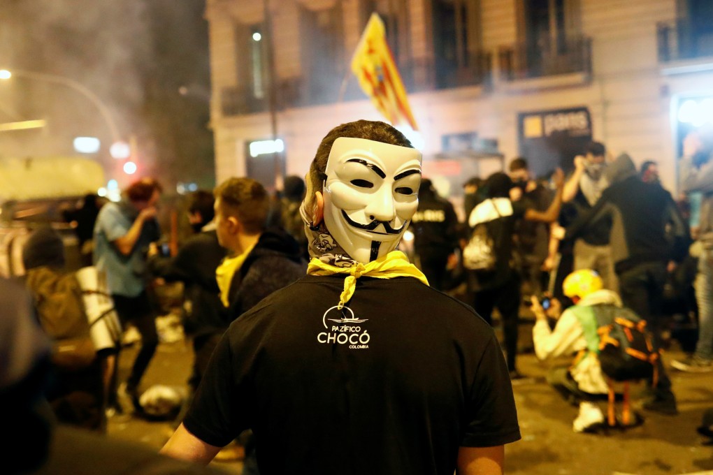 A demonstrator wears a Guy Fawkes mask during a general strike in Catalonia, Spain. Photo: Reuters