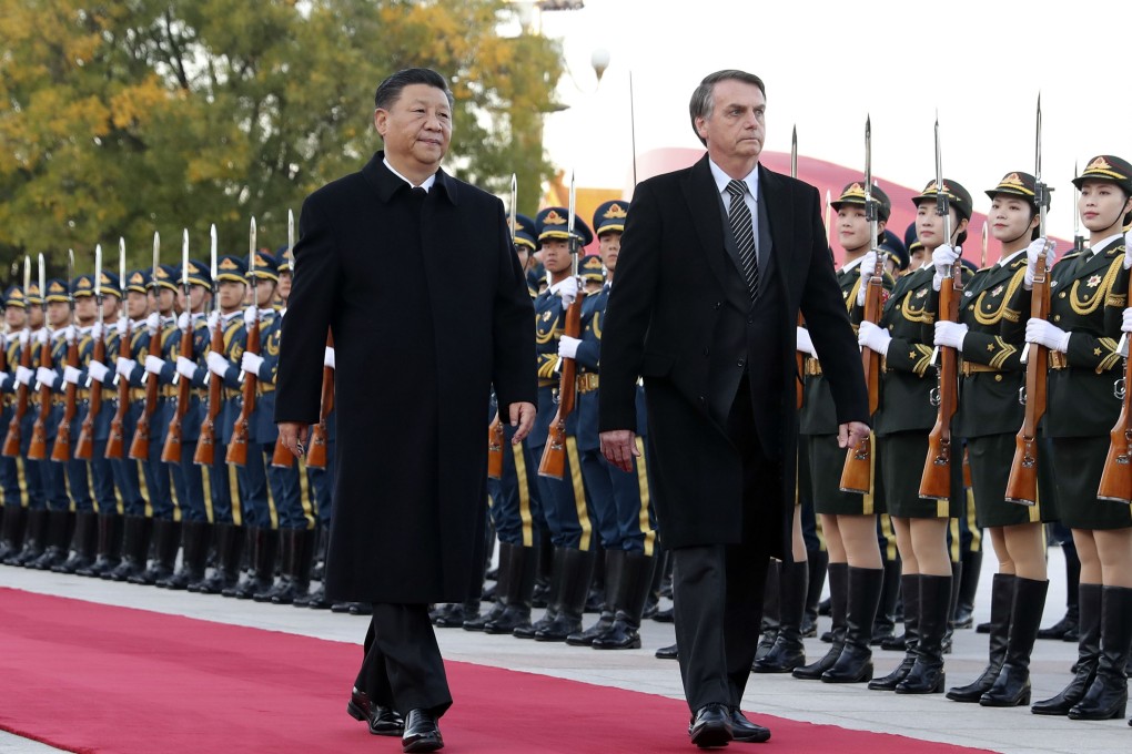 Chinese President Xi Jinping and Brazilian leader Jair Bolsonaro head into the Great Hall of the People in Beijing for talks on Friday. Photo: Xinhua