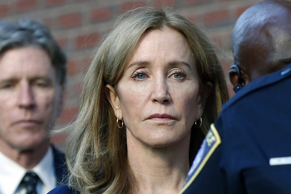 Actress Felicity Huffman leaves federal court in Boston with her brother Moore Huffman Jnr (left) in September, after she was sentenced in a nationwide college admissions bribery scandal. Photo: AP