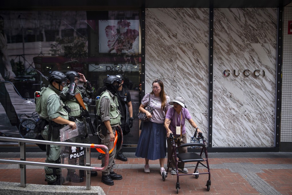 Riot police in front of a Gucci store in Hong Kong’s Causeway Bay district during a recent protest. The number of mainland tourists, the biggest category of visitors to the city annually, has fallen amid the unrest which is now in its fifth month. Photo: Bloomberg