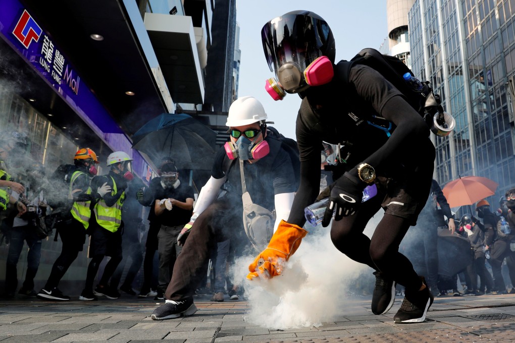 An anti-government protester holds a tear-gas canister during clashes with police on October 20. Photo: Reuters