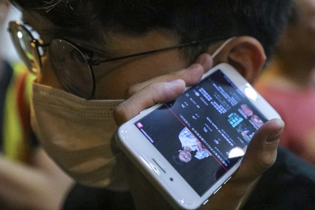 A protester listens to the dialogue session between Hong Kong Chief Executive Carrie Lam Cheng Yuet-ngor and the public in Wan Chai on September 26. Photo: May Tse