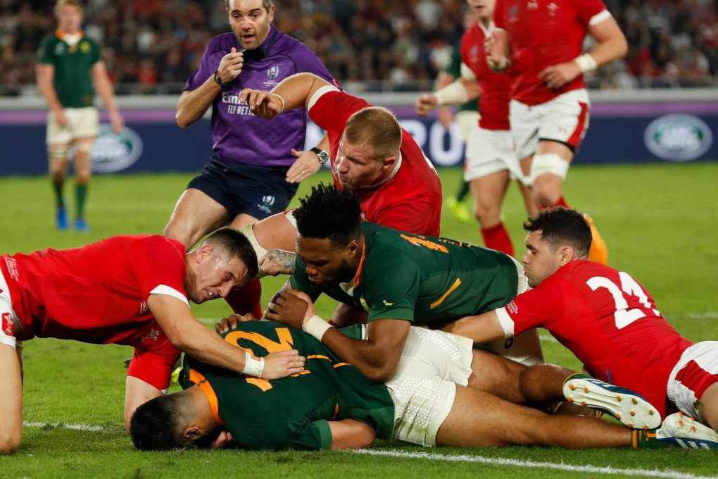 South Africa’s centre Damian De Allende (centre) scores a try during the Rugby World Cup semi-final match against Wales. Photo: AFP