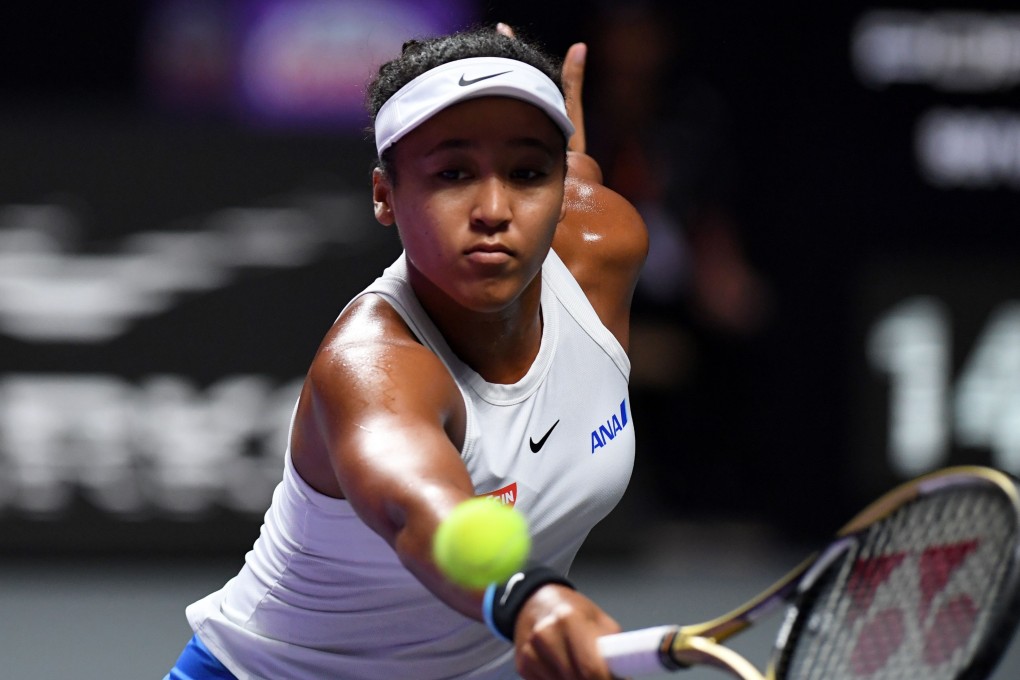 Japan’s Naomi Osaka hits a return against Czech star Petra Kvitova in their WTA Finals opener in Shenzhen. Photo: AFP