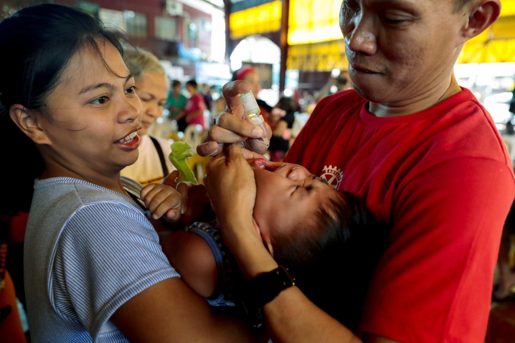 A health worker gives a child a free dose of polio vaccine during a government-led mass vaccination programme in Quezon City. Photo: Reuters