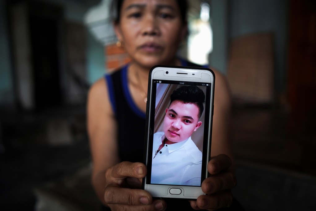 Hoang Thi Ai, 48, shows a picture of her son Hoang Van Tiep, who is suspected to be among the 39 people found dead in a refrigerated truck in Britain. Photo: Reuters