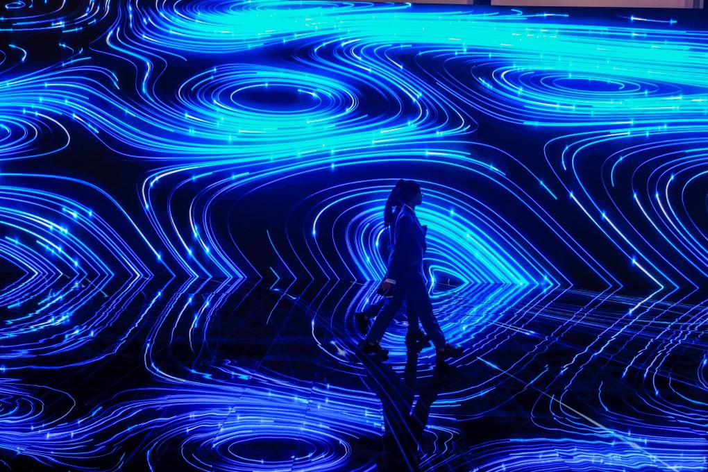 People walk before a screen in the Wuzhen International Internet Exhibition and Convention Center in the river town of Wuzhen, east China's Zhejiang Province, Oct. 19, 2019. Photo: Xinhua