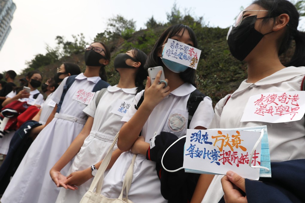 Students form a human chain at Ho Man Tin on Monday to protest against postponement of interschool sports matches. Photo: Nora Tam