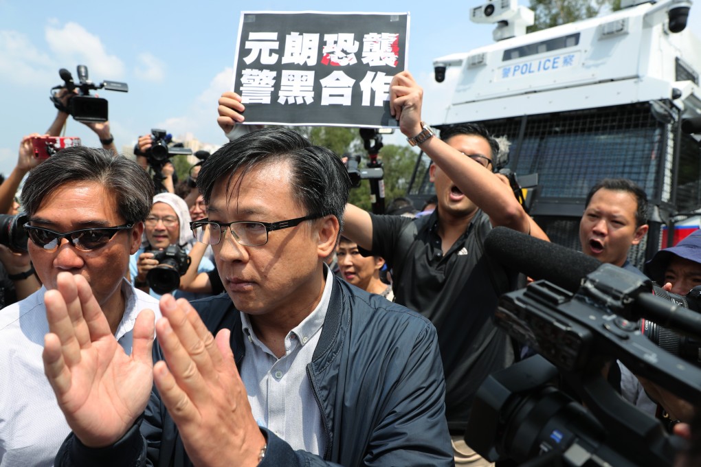 Pro-establishment lawmaker Junius Ho Kwan-yiu (front centre) walks away from the group of pan-democracy lawmakers rallying against him. Photo: Sam Tsang
