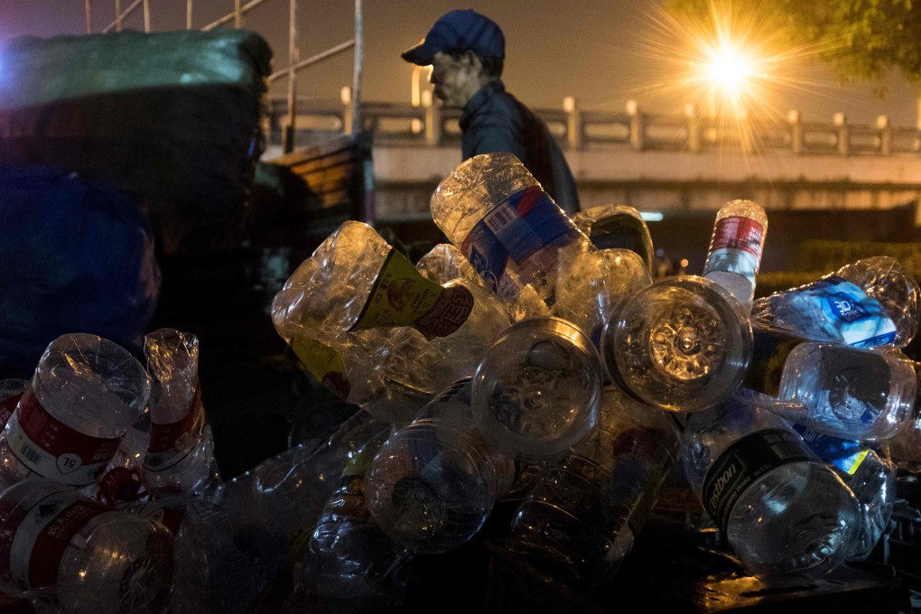 A scrap collector sorts plastic waste at a garbage dump in Shanghai. China’s coastal waters have seen a surge in waste, with plastic making up more than 80 per cent of floating rubbish. Photo: AFP