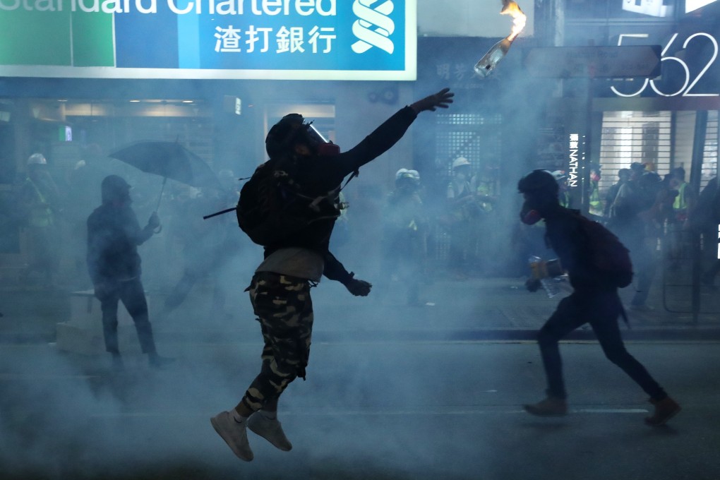 An anti-government protester hurls a petrol bomb during clashes with riot police in Mong Kok on October 20. Photo: Sam Tsang