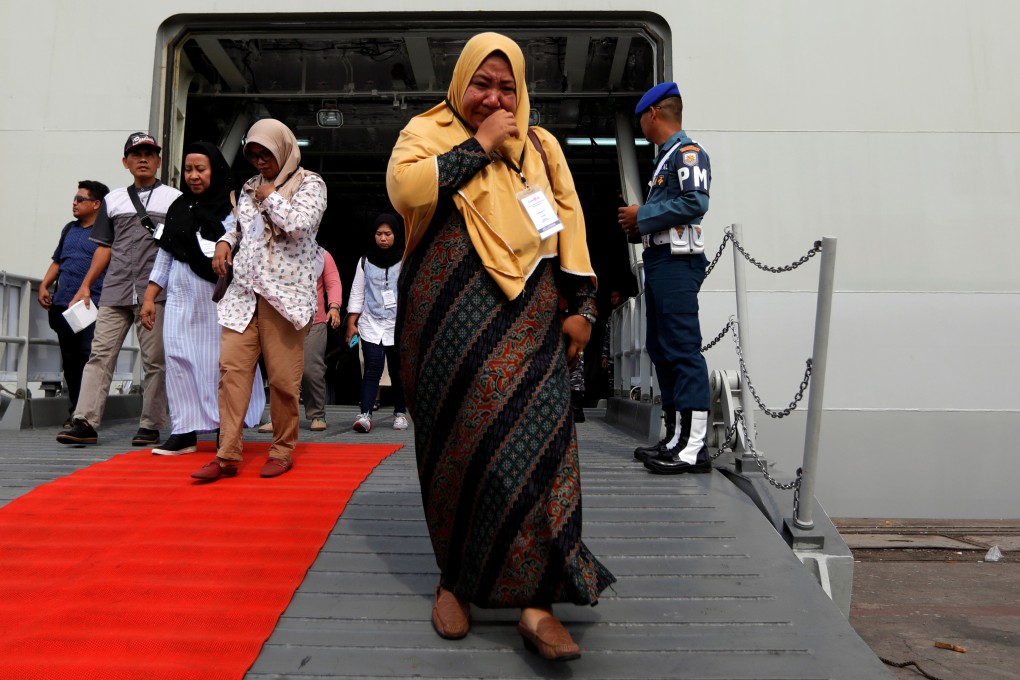 A relative of a passenger who died in the Lion Air crash arrives in Jakarta after attending the one-year commemoration. Photo: Reuters