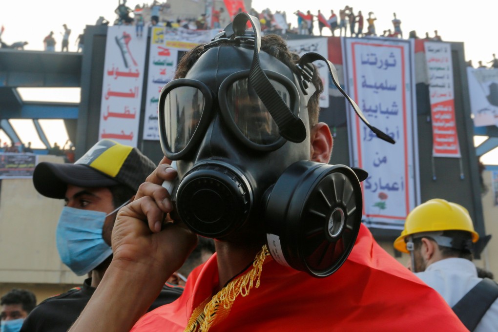A demonstrator wears a mask to protect himself from tear gas during a protest in Baghdad. Photo: Reuters