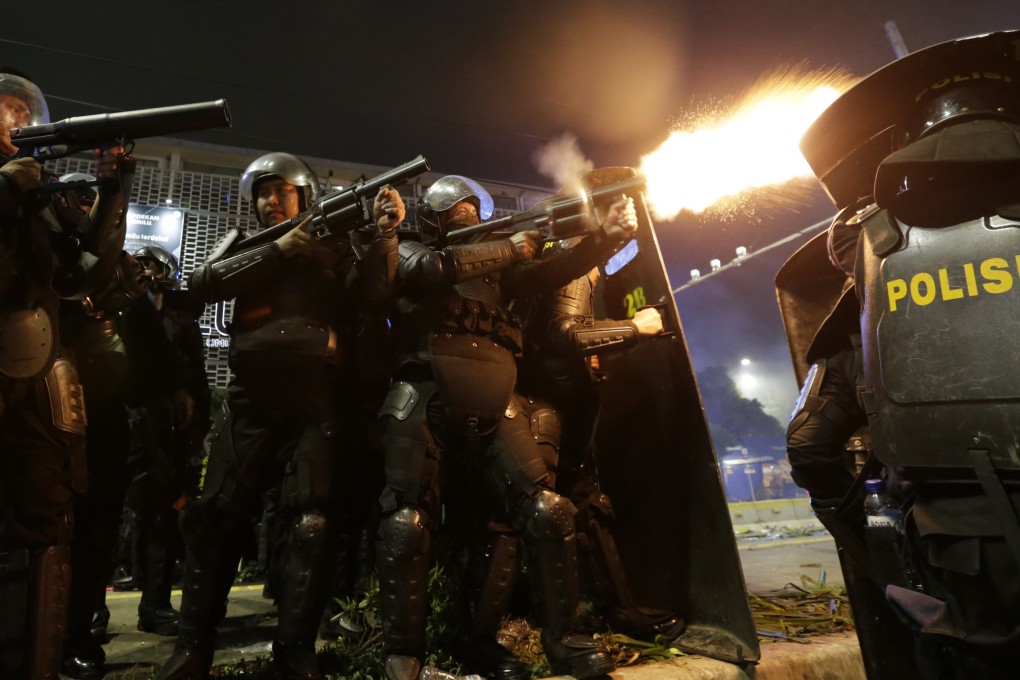 Riot police fire at supporters of Indonesian presidential candidate Prabowo Subianto during clashes in Jakarta on May 22. Photo: AP