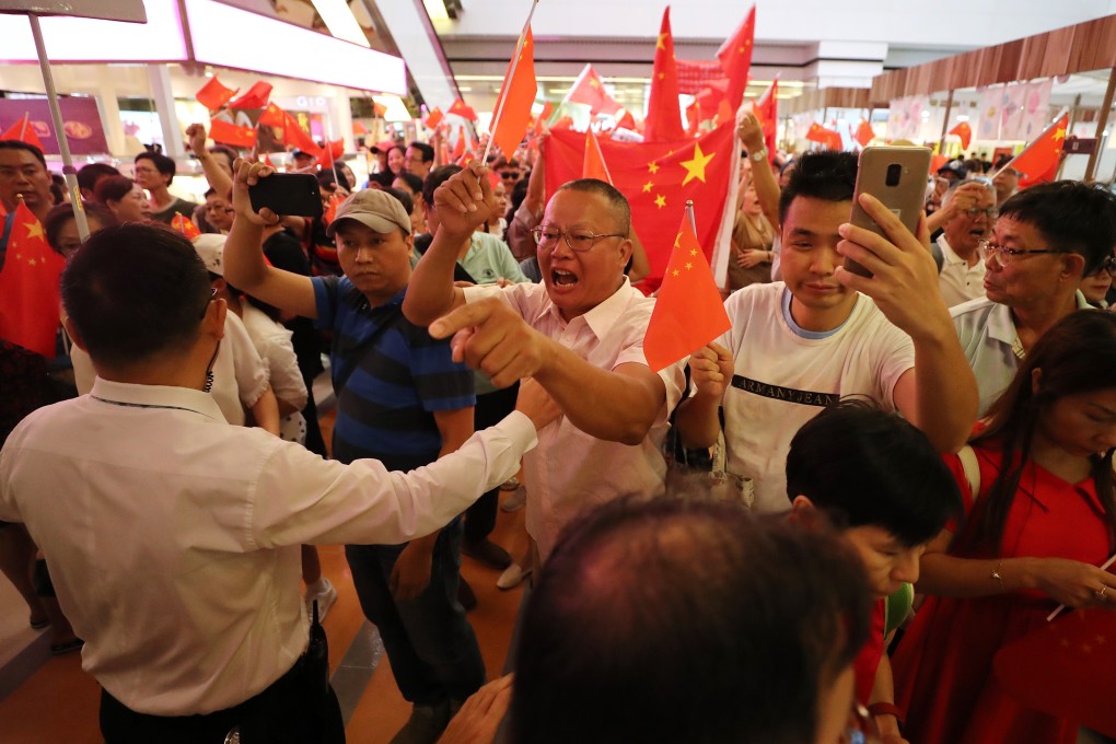 Pro-Beijing supporters wave Chinese flags during a confrontation between rival camps at Amoy Plaza, Kowloon Bay on September 14. Photo: Sam Tsang