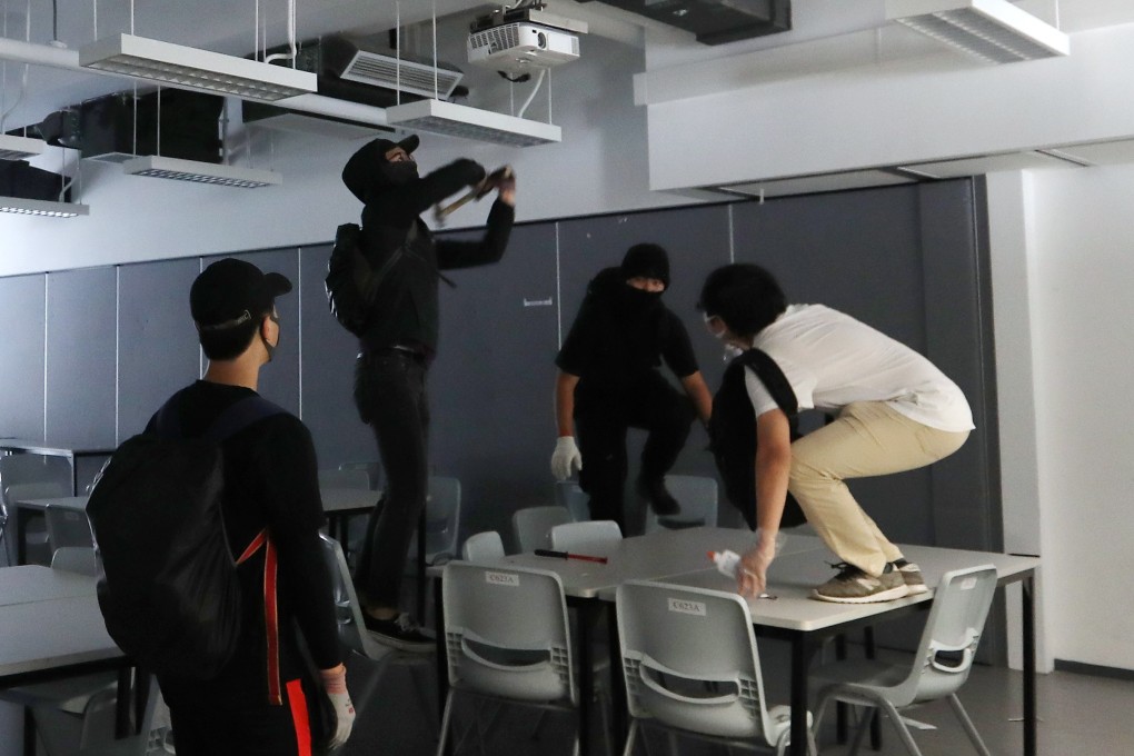 Masked students vandalise classrooms at the Hong Kong Design Institute. Photo: Xiaomei Chen