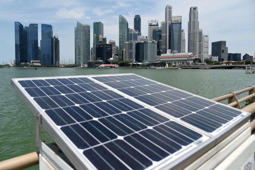 Solar panels used to power walkway lights are seen on Marina Bay. Singapore aims to widen the use of solar power by 2030. Photo: AFP