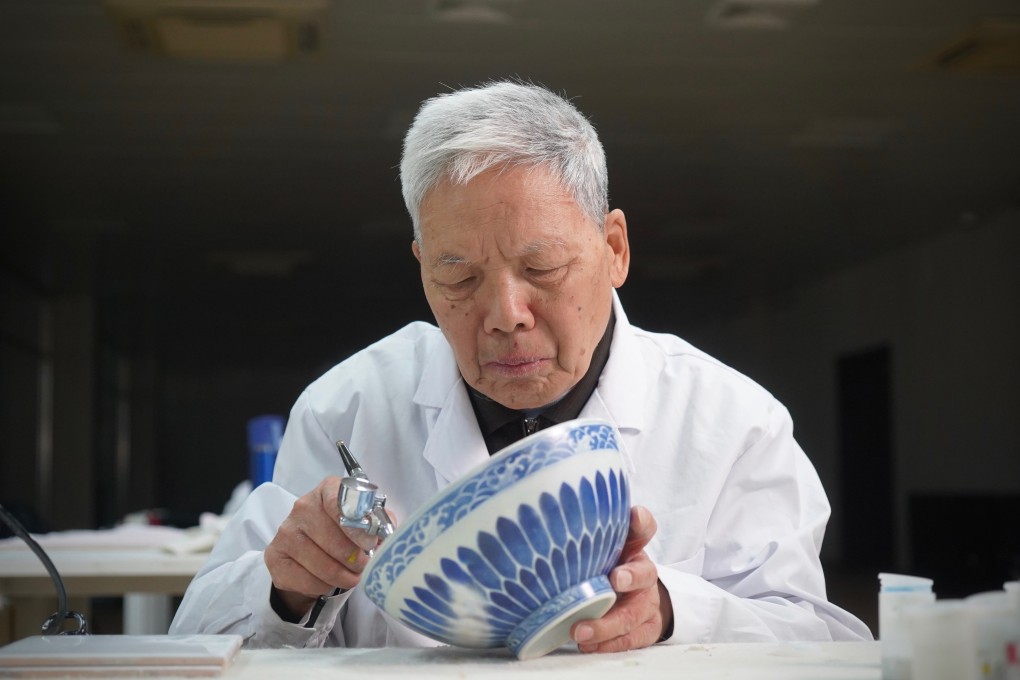Wang Mian, technical adviser to the “Restore 1860” programme to reassemble broken pottery pieces from Beijing’s Old Summer Palace, checks work on a restored artefact. Photo: Tom Wang