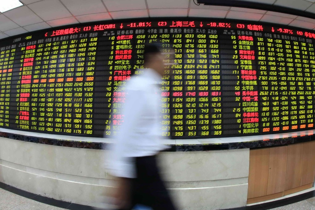 An investor passes by an electronic board displaying stock prices at a brokerage house in Shanghai on August 8, 2011. Photo: Xinhua