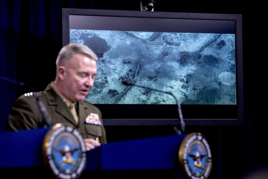 Video of the raid is displayed as Marine General Kenneth McKenzie briefs reporters at the Pentagon on Wednesday. Photo: AP