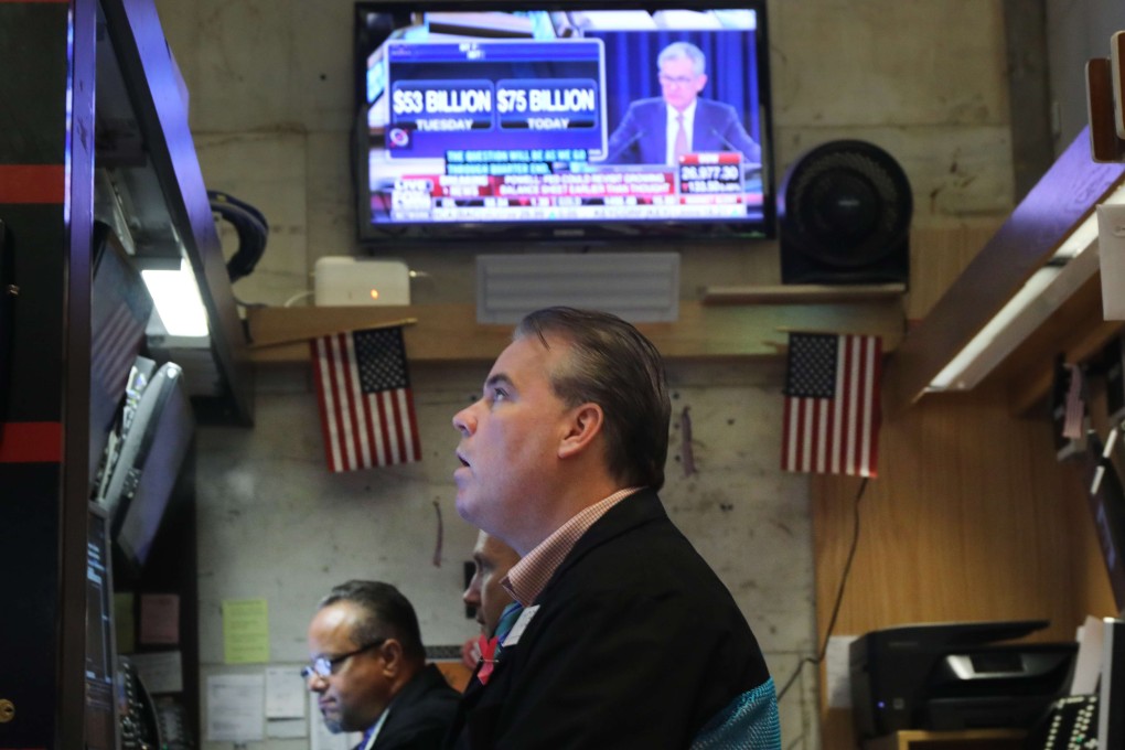 Traders work at the New York Stock Exchange as Federal Reserve Chairman Jerome Powell gives a news conference on September 18. As concerns about a global economic slowdown mount, the Fed cut interest rates by a quarter of a percentage point for the second time since July. Photo: AFP