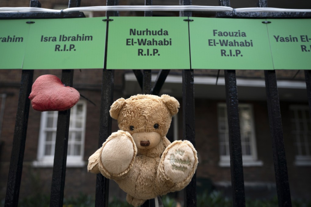 A teddy bear is placed on names of victims in tributes close to Grenfell Tower in London on Wednesday. Photo: EPA-EFE