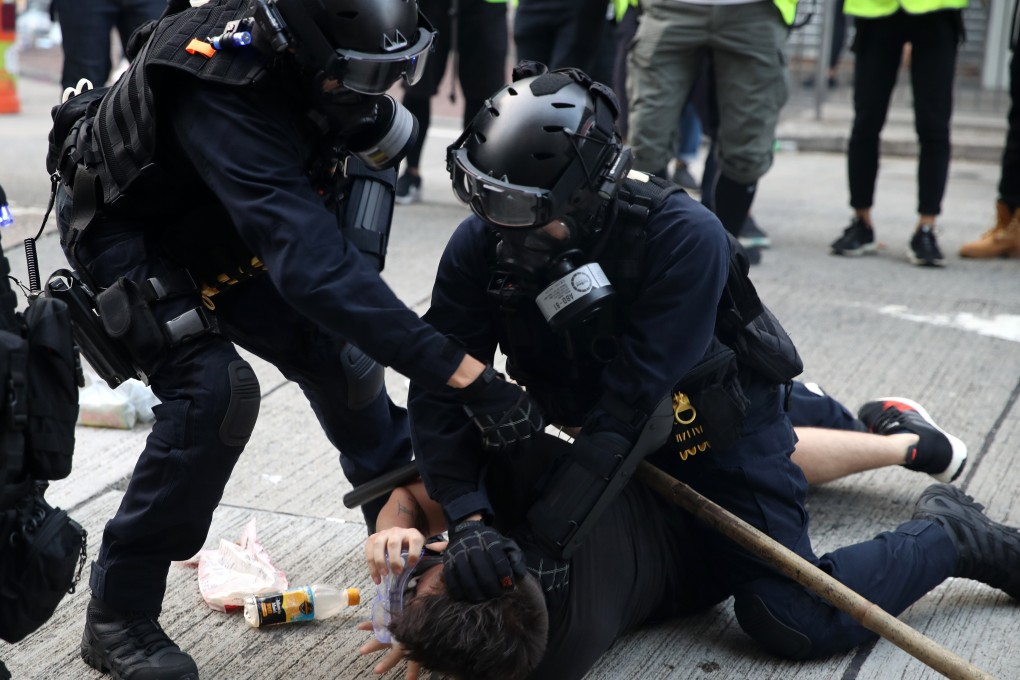 Riot police arrest an anti-government protester in Prince Edward on October 20. While different sectors have demanded an inquiry into police misconduct during the protests, the Hong Kong government insists that the public wait for an Independent Police Complaints Council report. Photo: Winson Wong