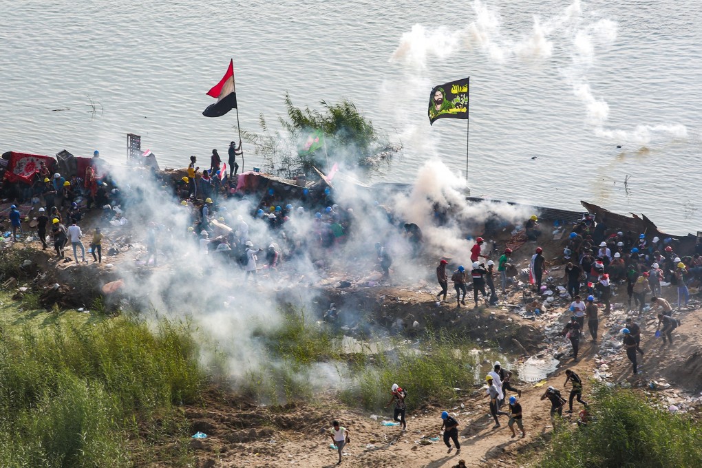 Tear gas is fired during clashes between anti-government protesters and Iraqi security forces near Tahrir Square in Baghdad on Thursday. Photo: dpa