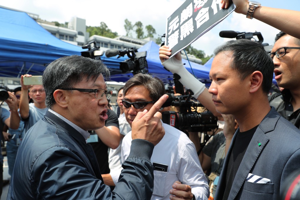 Lawmaker Junius Ho (left) exchanges words with Dennis Kwok at the demonstration of the water cannon at police headquarters in Fanling. Photo: Sam Tsang