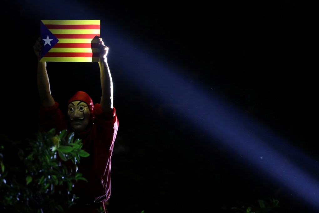 An anti-government demonstrator in Chater Garden, Hong Kong, on October 24 holds a Catalan flag to show solidarity with Catalonia’s independence movement. Photo: Reuters