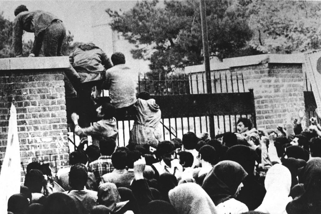 Iranian revolutionary students climb the US embassy's gate in Tehran in 1979. Photo: AFP