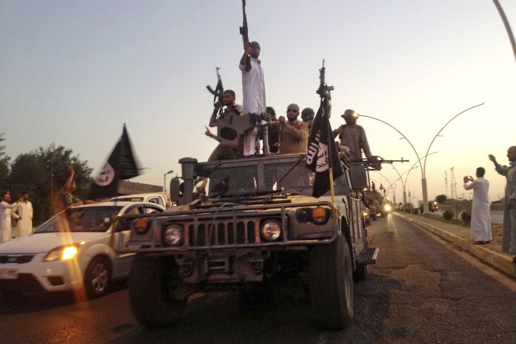 Islamic State fighters in a commandeered Iraqi security forces armoured vehicle in 2014. Photo: AP