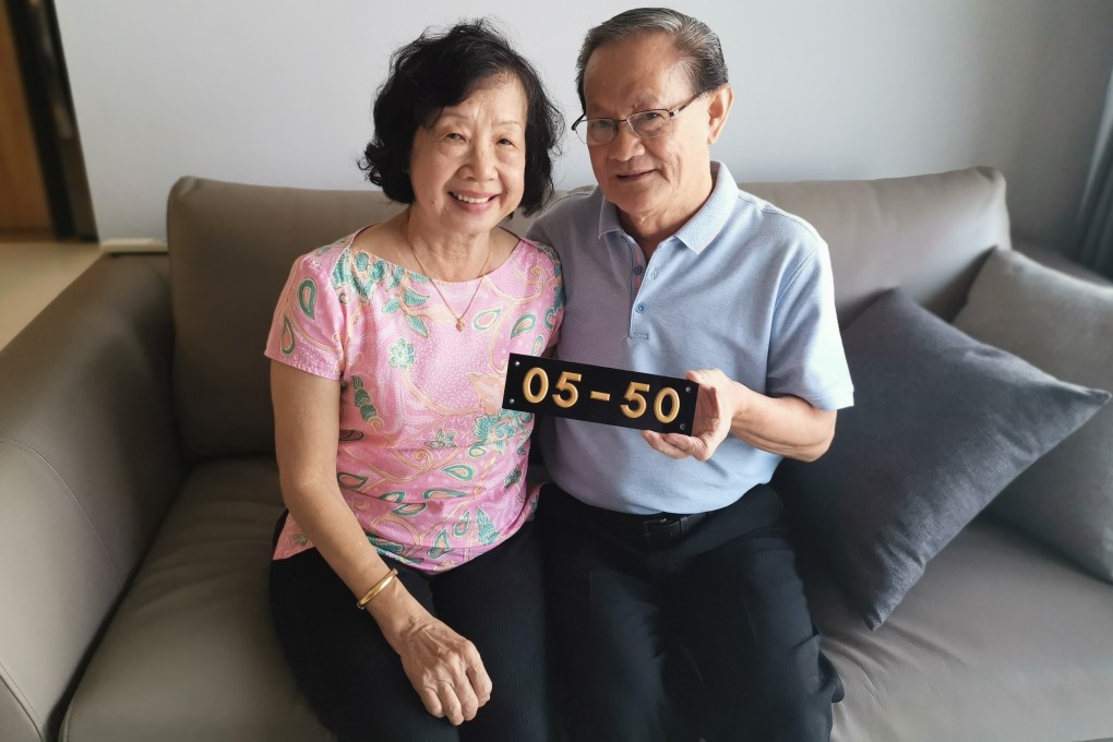 The Chungs with their old unit number from Shunfu Ville, at their new place in Sengkang. Photo: Derek Wong