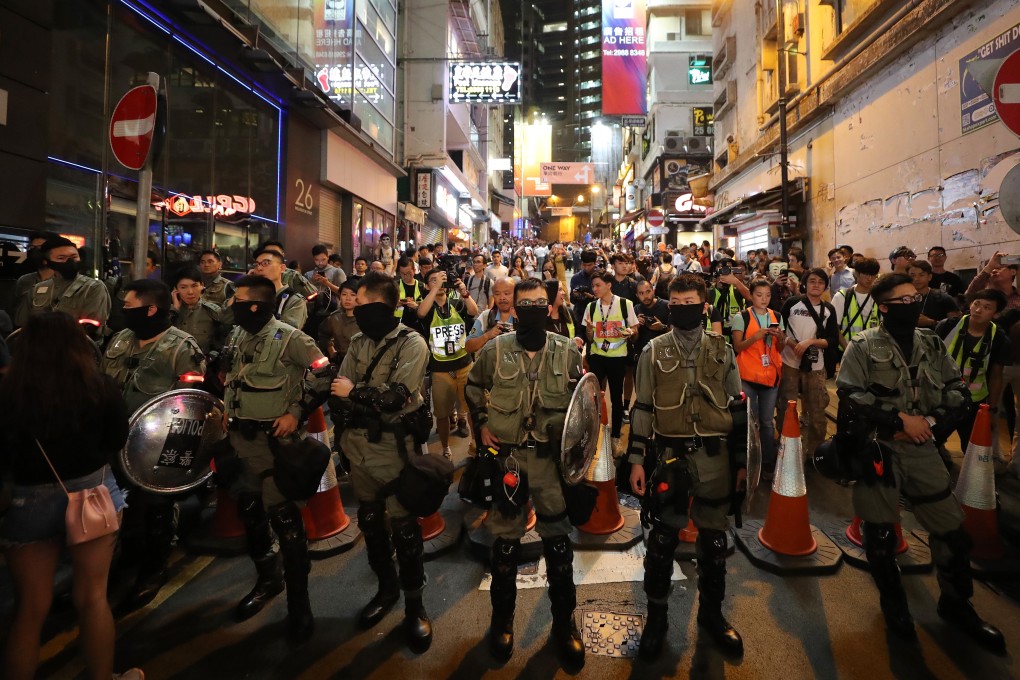 Police officers block the road in Lan Kwai Fong, Central on Halloween night. Photo: Sam Tsang