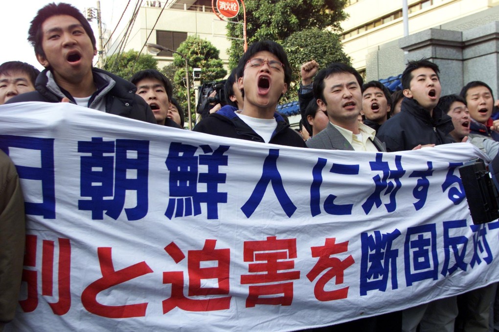 File photo of protesters in Japan holding up banners denouncing the “discrimination and persecution against North Koreans” in 2001. File photo: AP