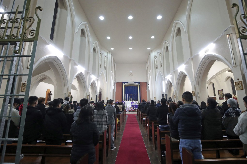 A vigil is held at the Holy Name and Our Lady of the Sacred Heart Church, a Vietnamese church in East London. Photo: AP
