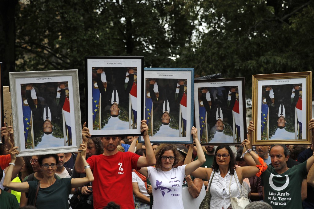 Demonstrators hold upside down portraits of French President Emmanuel Macron during a protest in Bayonne in August. Photo: AP