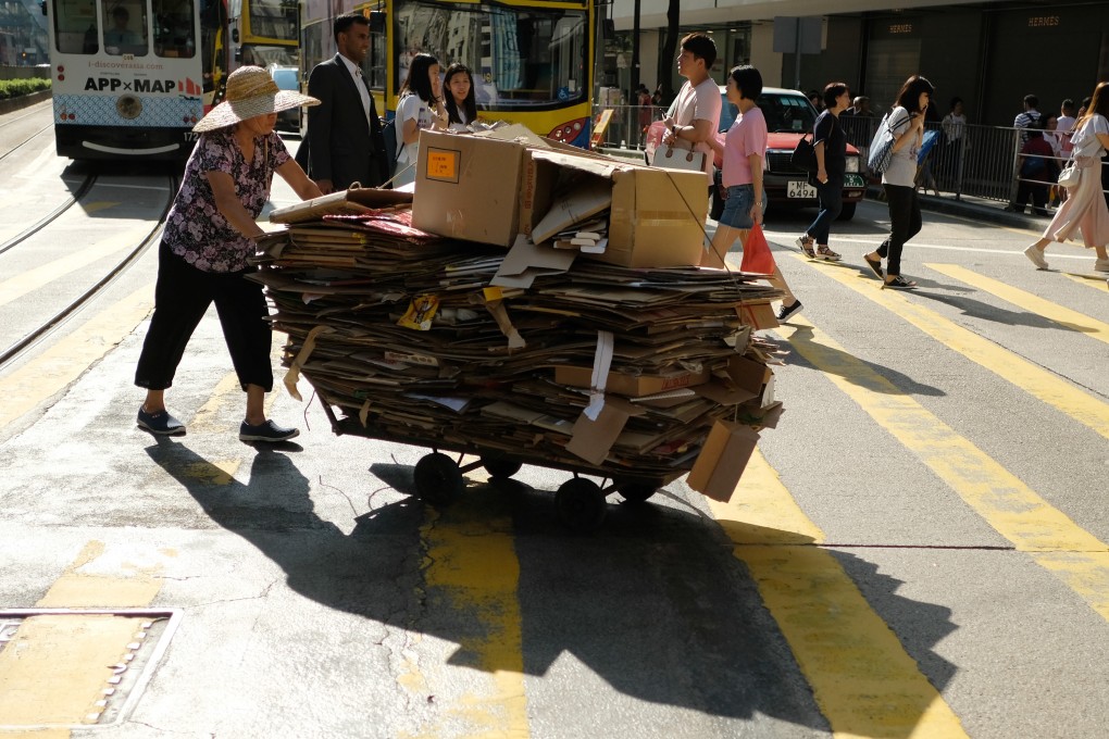 A woman pushes a trolley full of cardboard in Causeway Bay, in September 2018. Elderly people collecting cardboard for sale are a common sight on the streets of Hong Kong, where income inequality is high. Photo: Fung Chang
