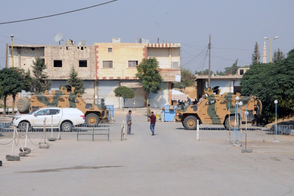Members of the Turkish forces and allied Syrian rebels patrol in Tel Abyad, Syria. Photo: Xinhua
