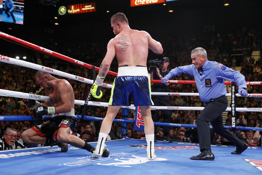 Canelo Alvarez stands over Sergey Kovalev as referee Russel Mora steps in. Photo: AP