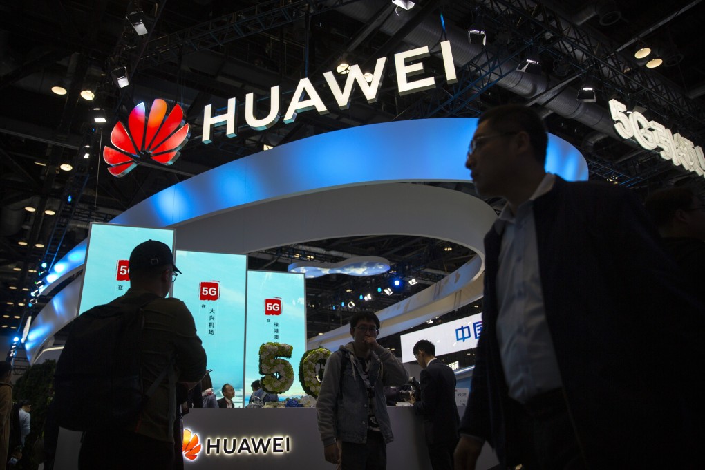 Attendees walk past a display for 5G services from Chinese technology firm Huawei at the PT Expo in Beijing, Oct. 31, 2019. Photo: AP