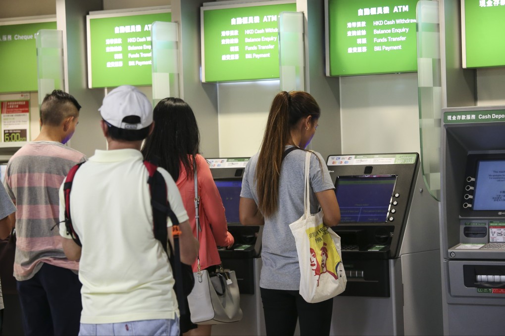 People queue up at the ATM in Central. Photo: David Wong
